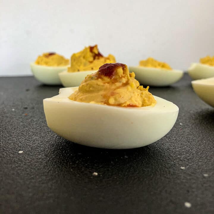 Spicy Deviled eggs with drop of hot sauce on top.