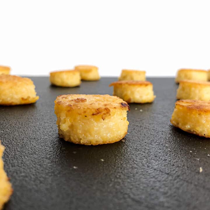 Grilled polenta cakes on board.