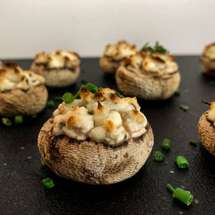 Baked mushrooms caps stuffed with fresh herbs and goat cheese mixture.