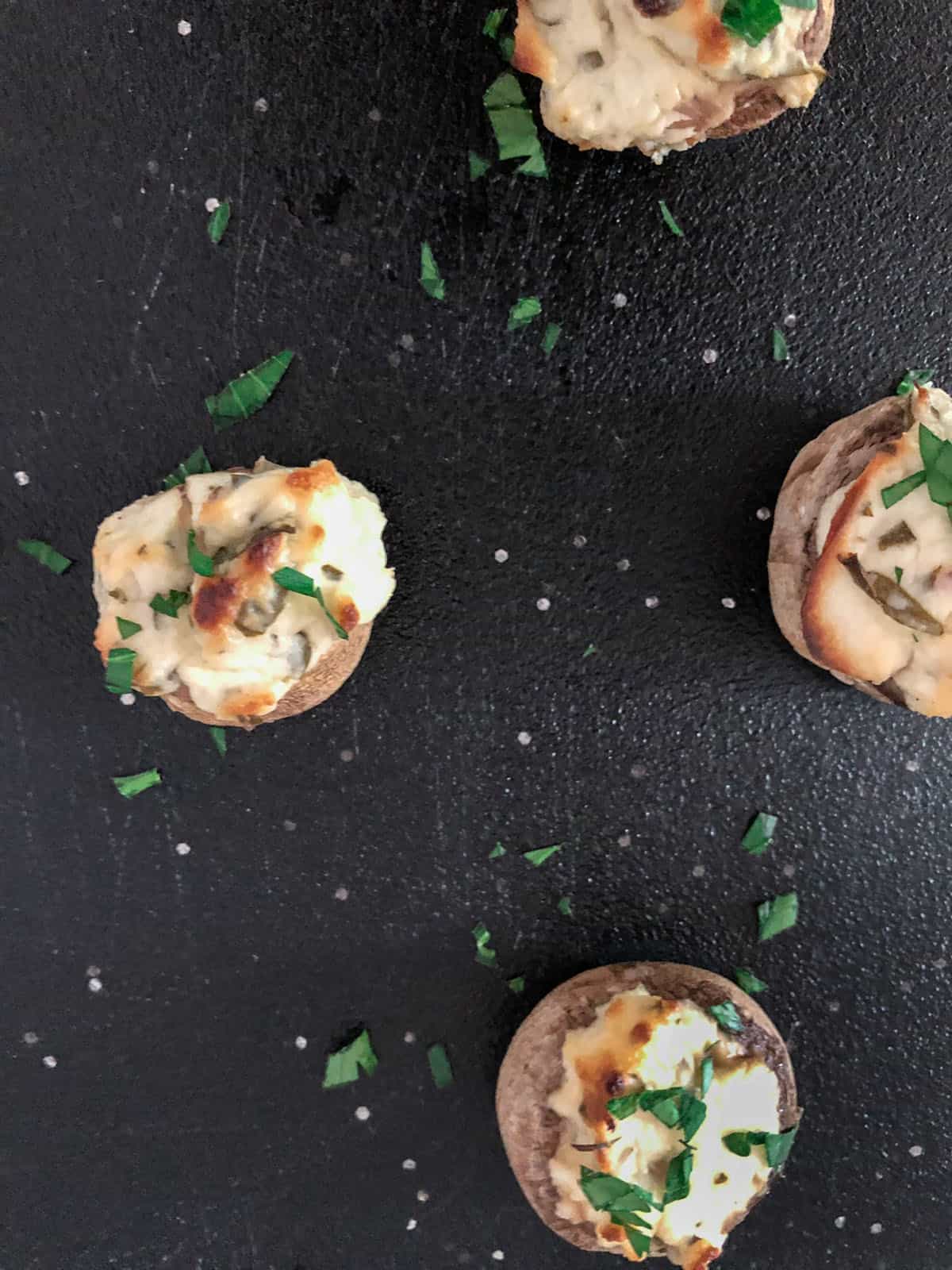 Baked cheese stuffed mushrooms on a tray.