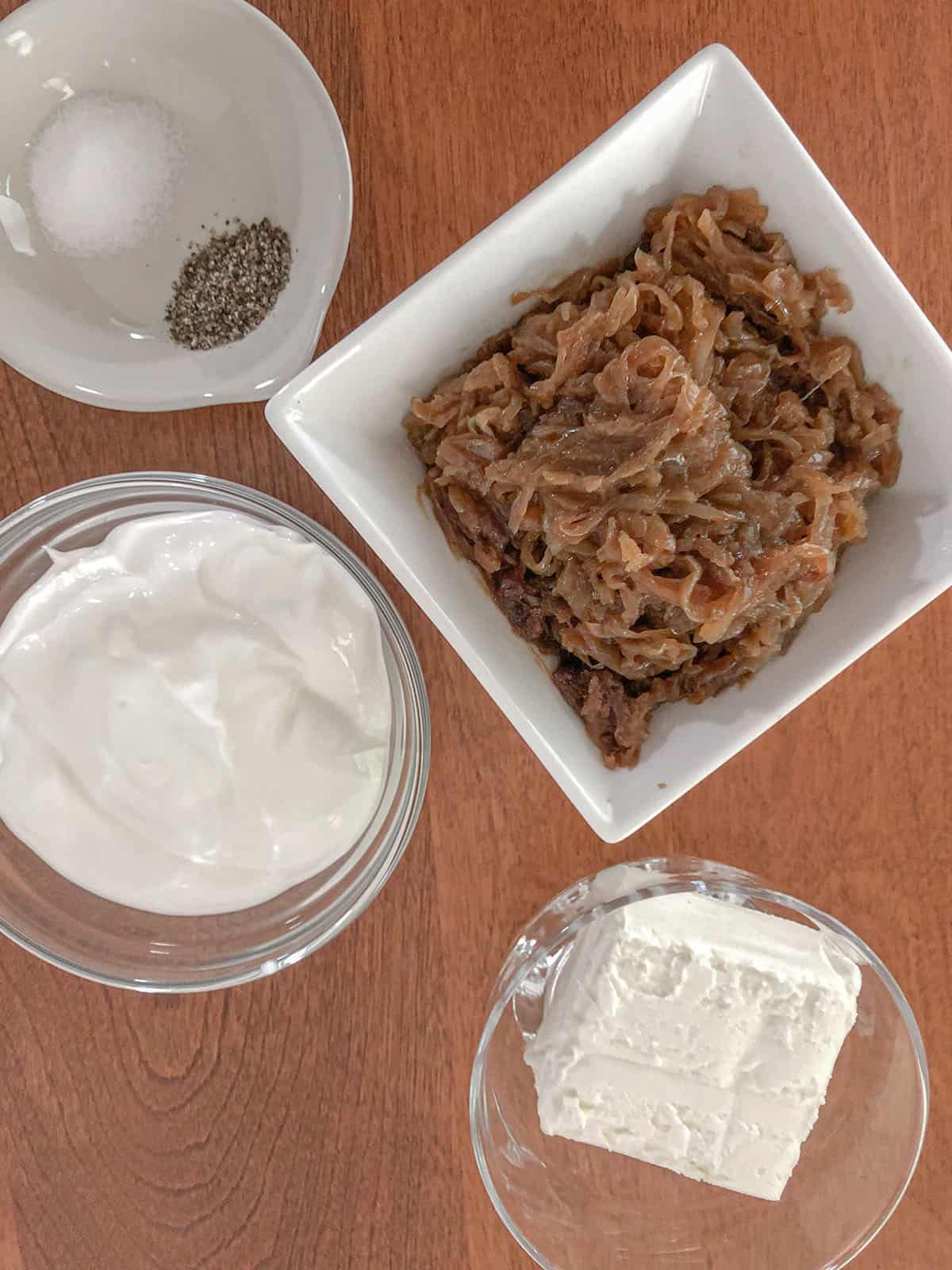 Caramelized onions, cream cheese, sour cream, salt and pepper in individual dishes.
