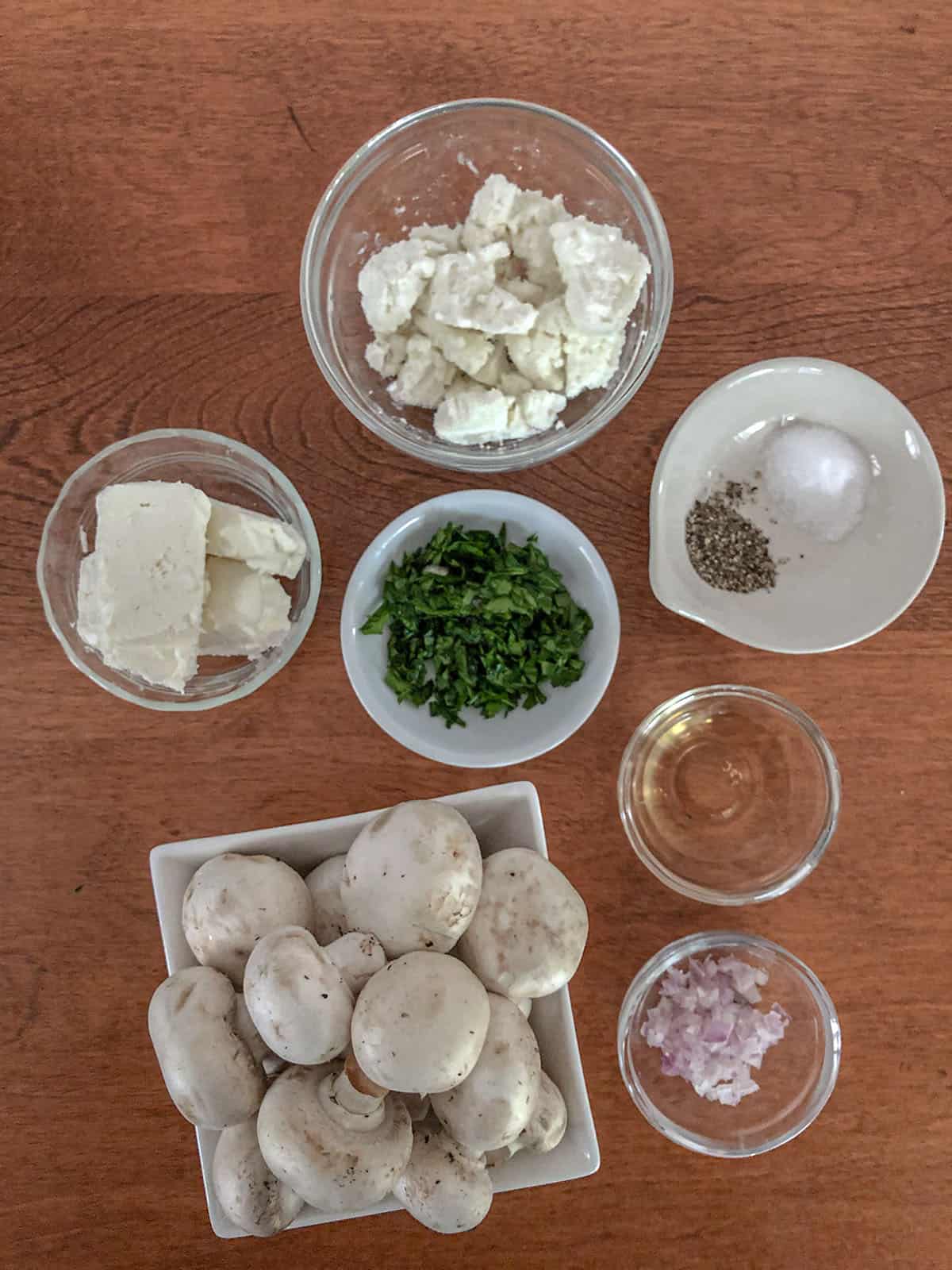 Mushrooms, diced shallots, cream cheese, goat cheese, chopped parsley, sherry, and salt and pepper in individual dishes.
