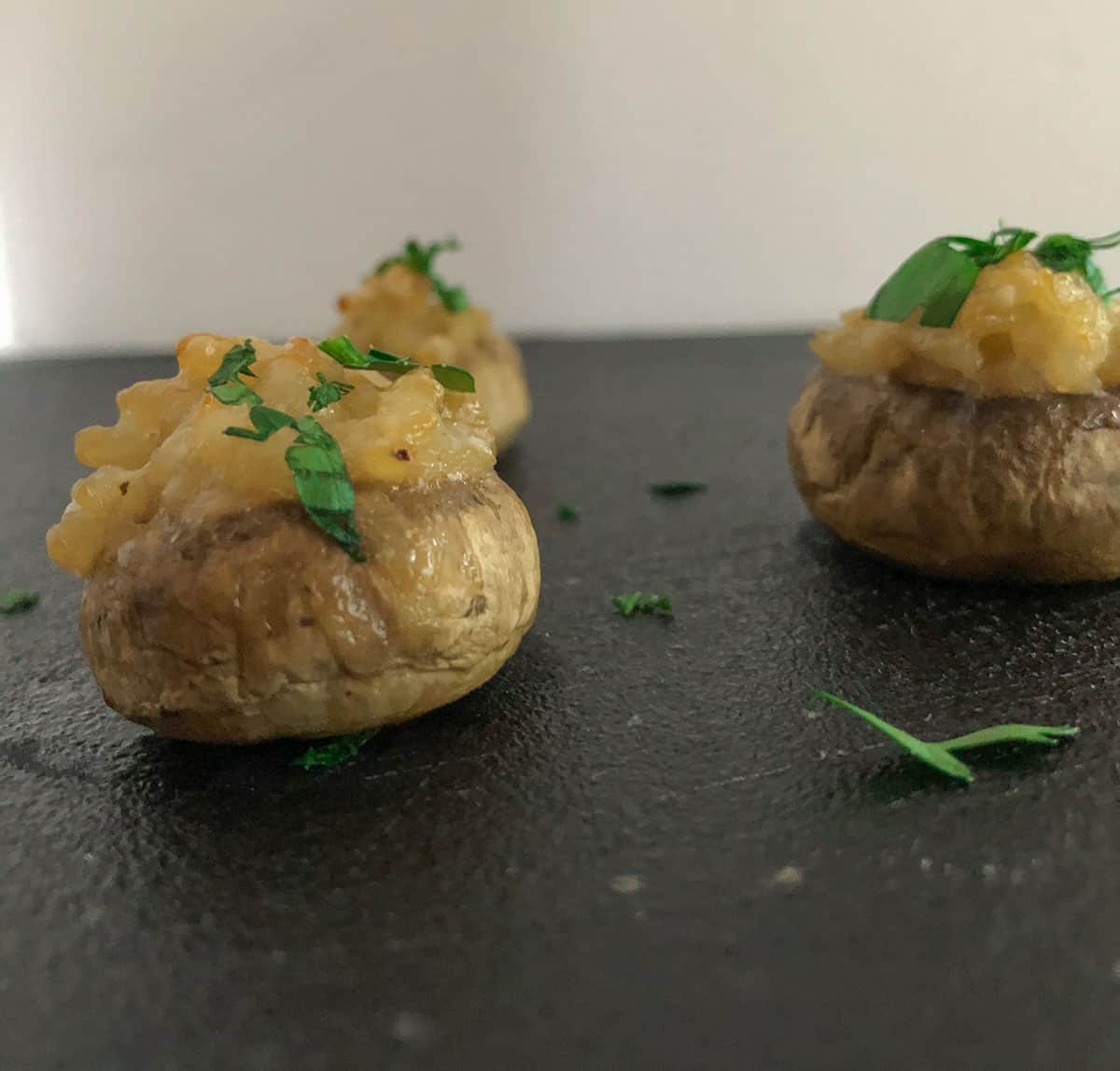 Mushroom filled with risotto and topped with parsley.