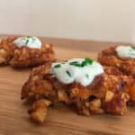 Tater tot waffle topped with sour cream dip.
