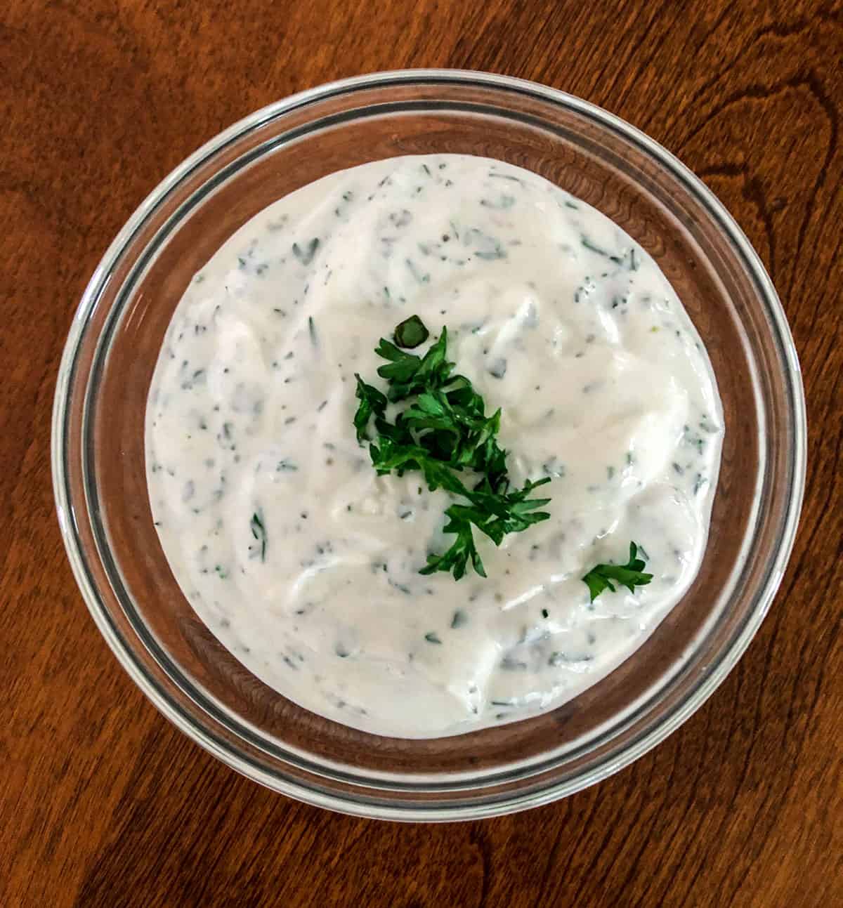 Herb dip in a glass bowl.