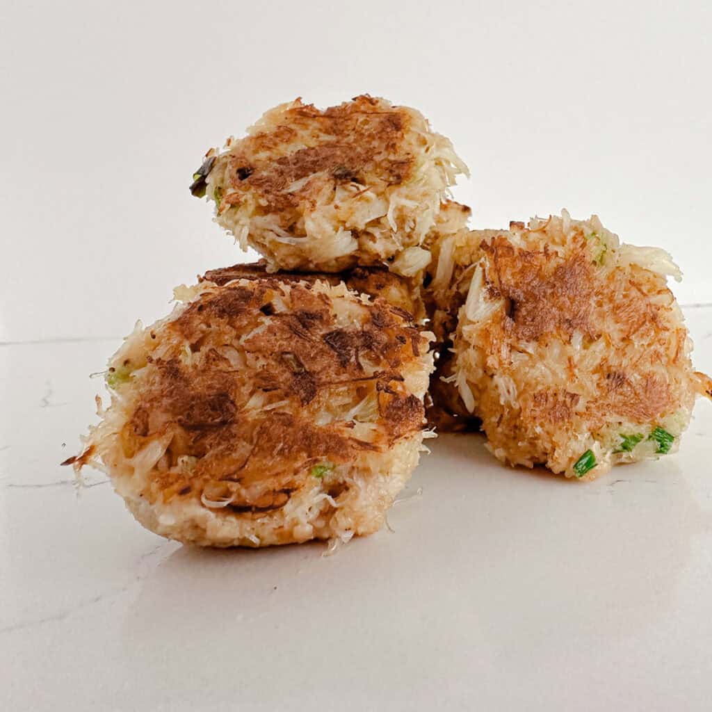A stack of fried crab cakes on a table.