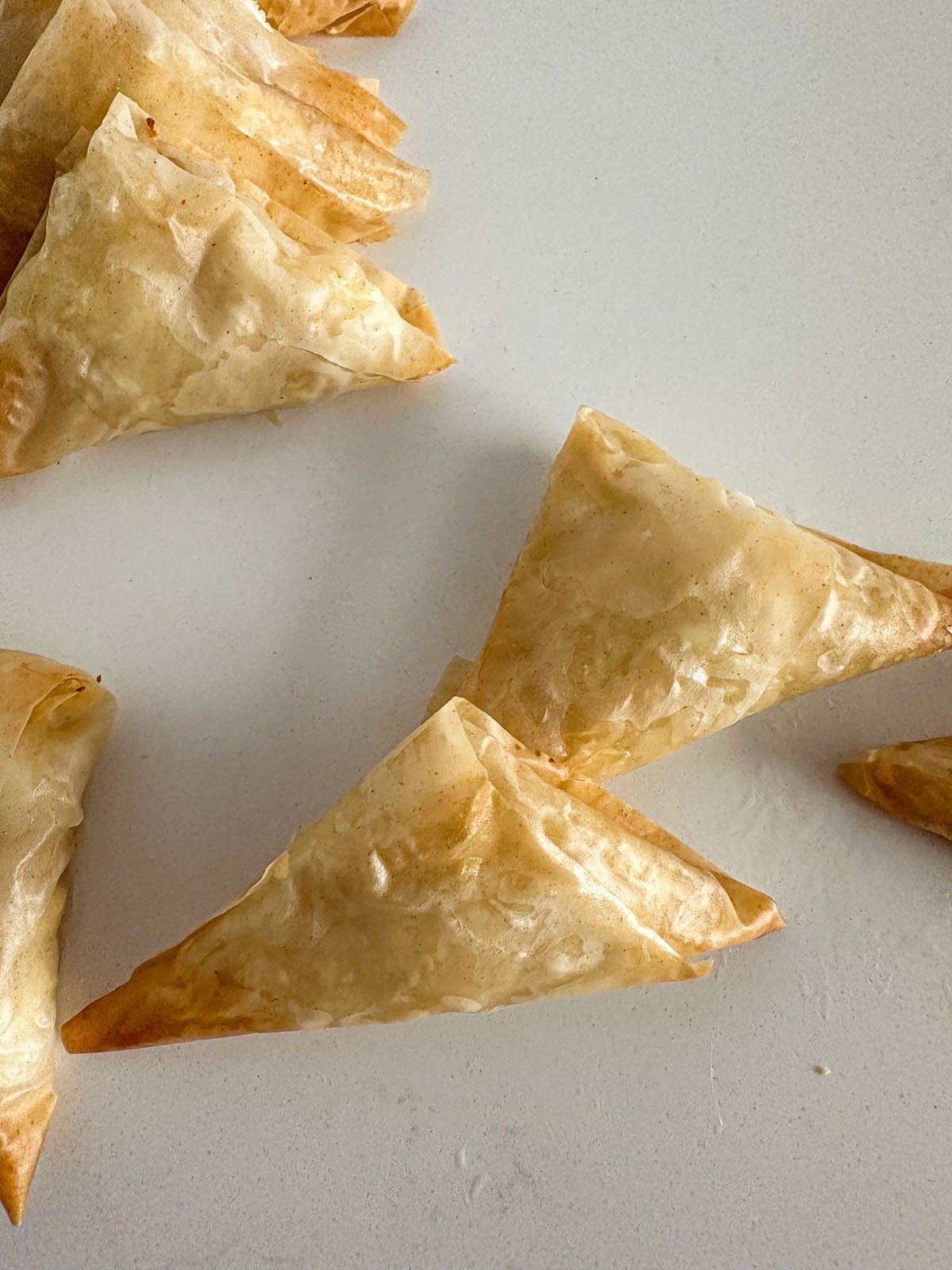 Baked, crispy phyllo triangles filled with crumbled feta cheese and hot honey.