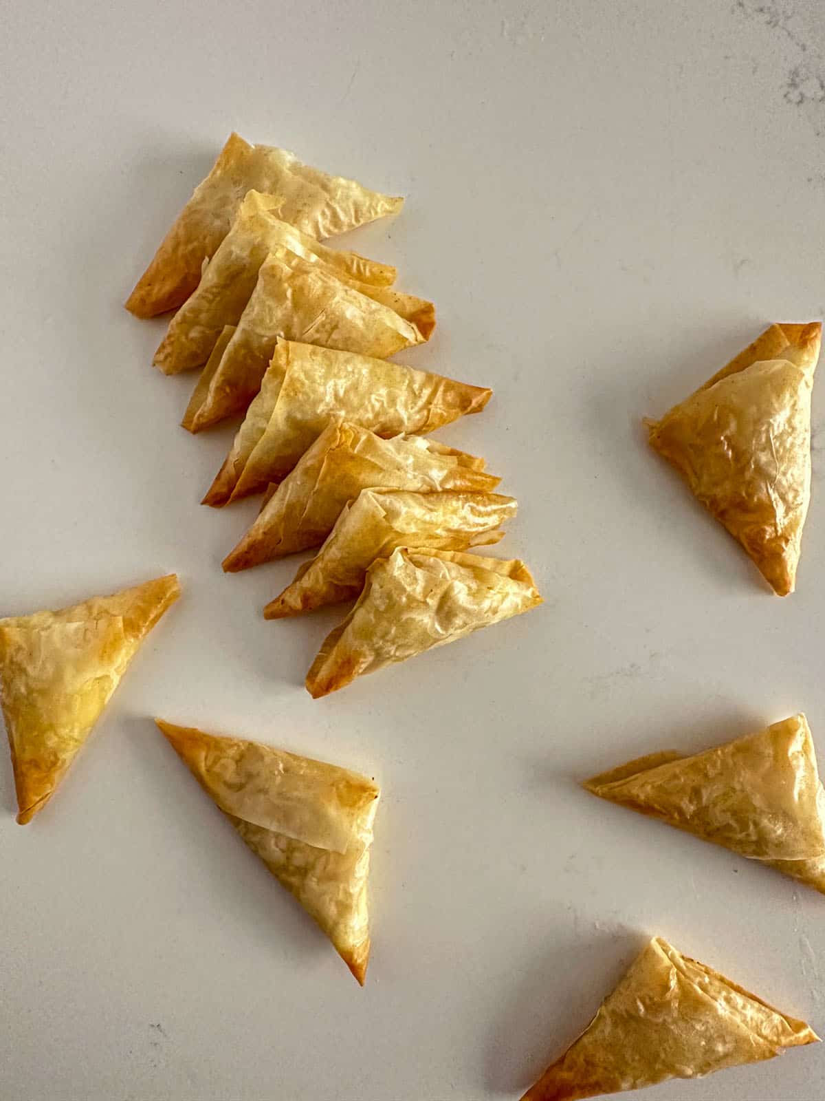 Baked phyllo dough triangles filled with feta cheese and hot honey.