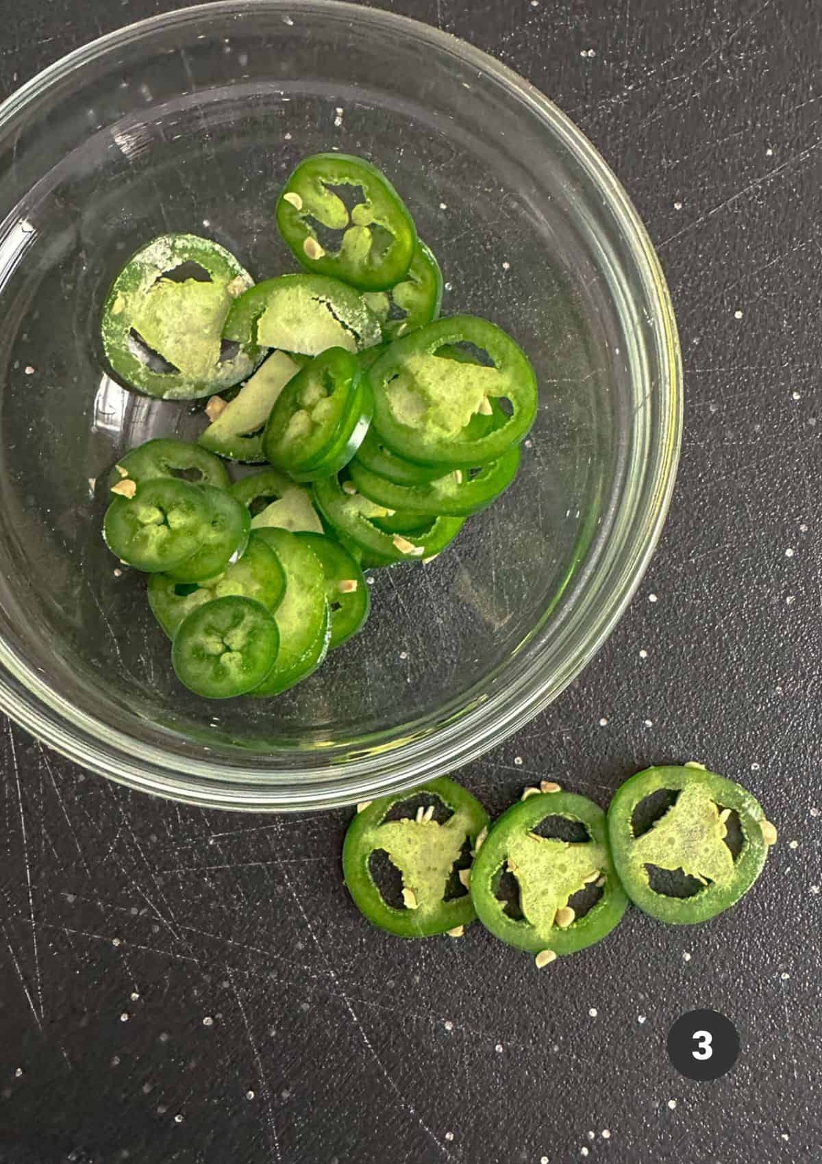 Rings of jalapeño in a dish for topping the biscuits.
