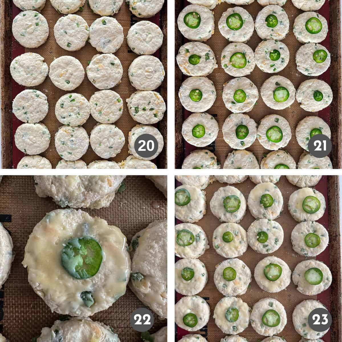Unbaked biscuits on a sheet pan, topped with a slice of jalapeño and butter.