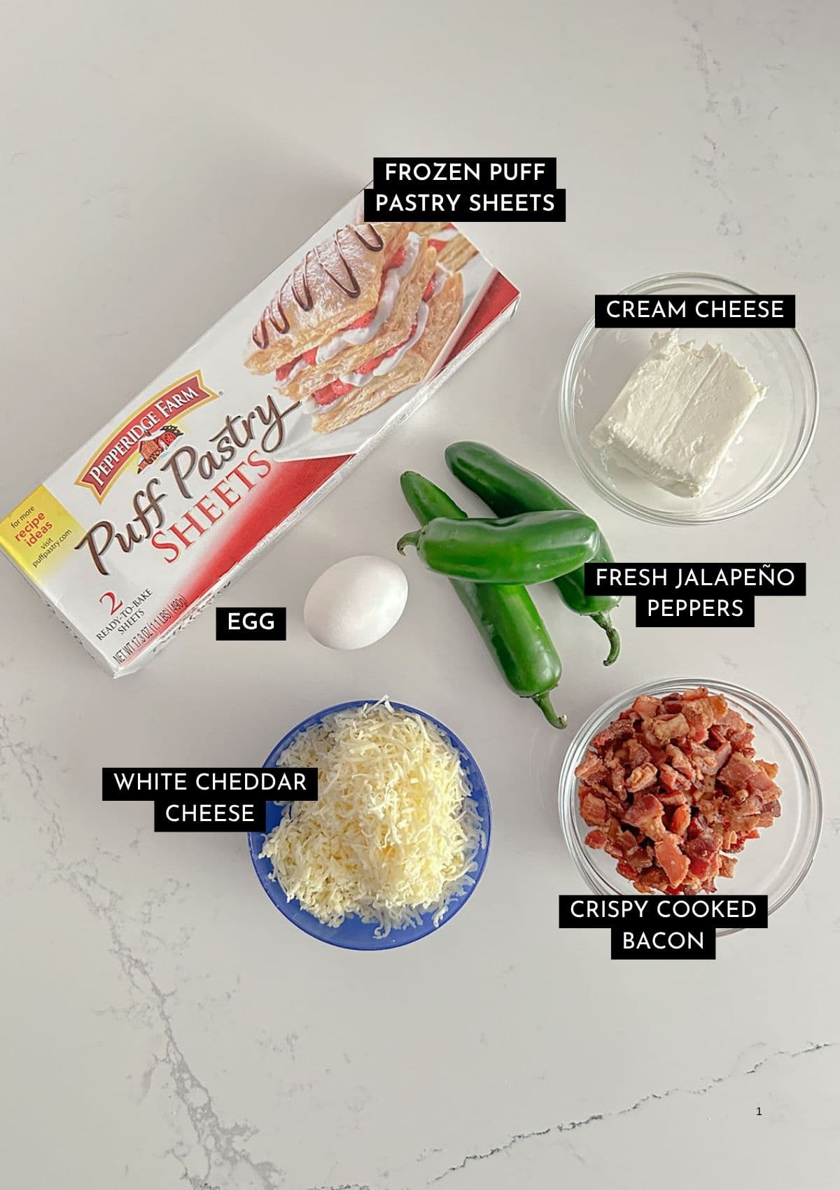 Puff pastry, jalapeños, cream cheese, white cheddar cheese, crispy chopped bacon, and an egg in individual containers.