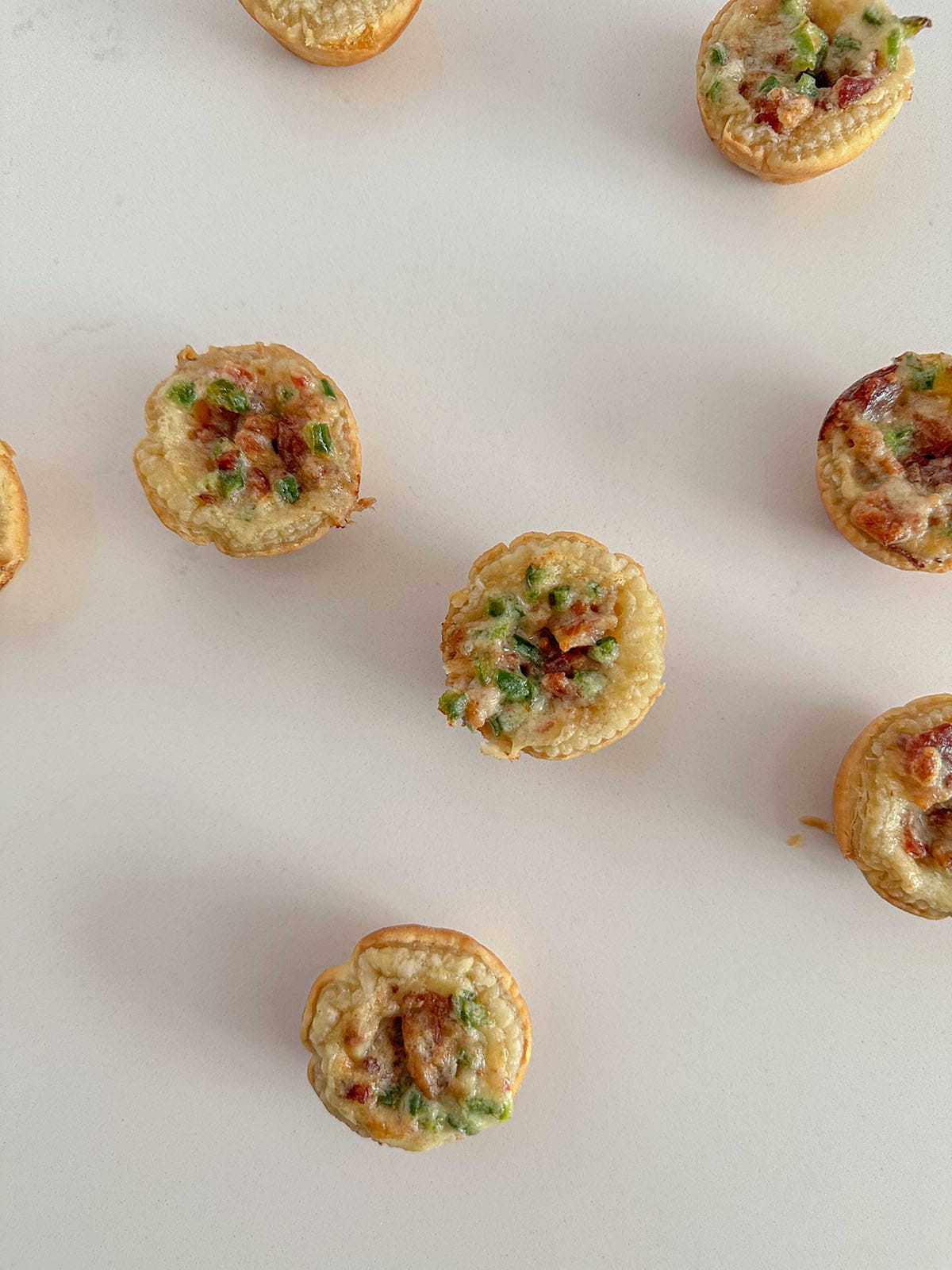 Puff pastry jalapeño popper cups on a counter.