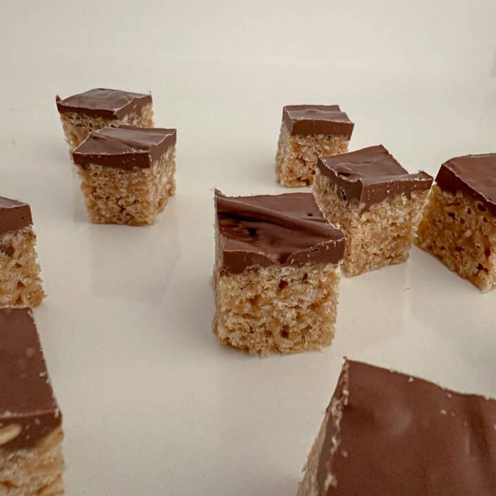 Pieces or crispy rice cereal, peanut butter, chocolate and butterscotch bars on a counter.