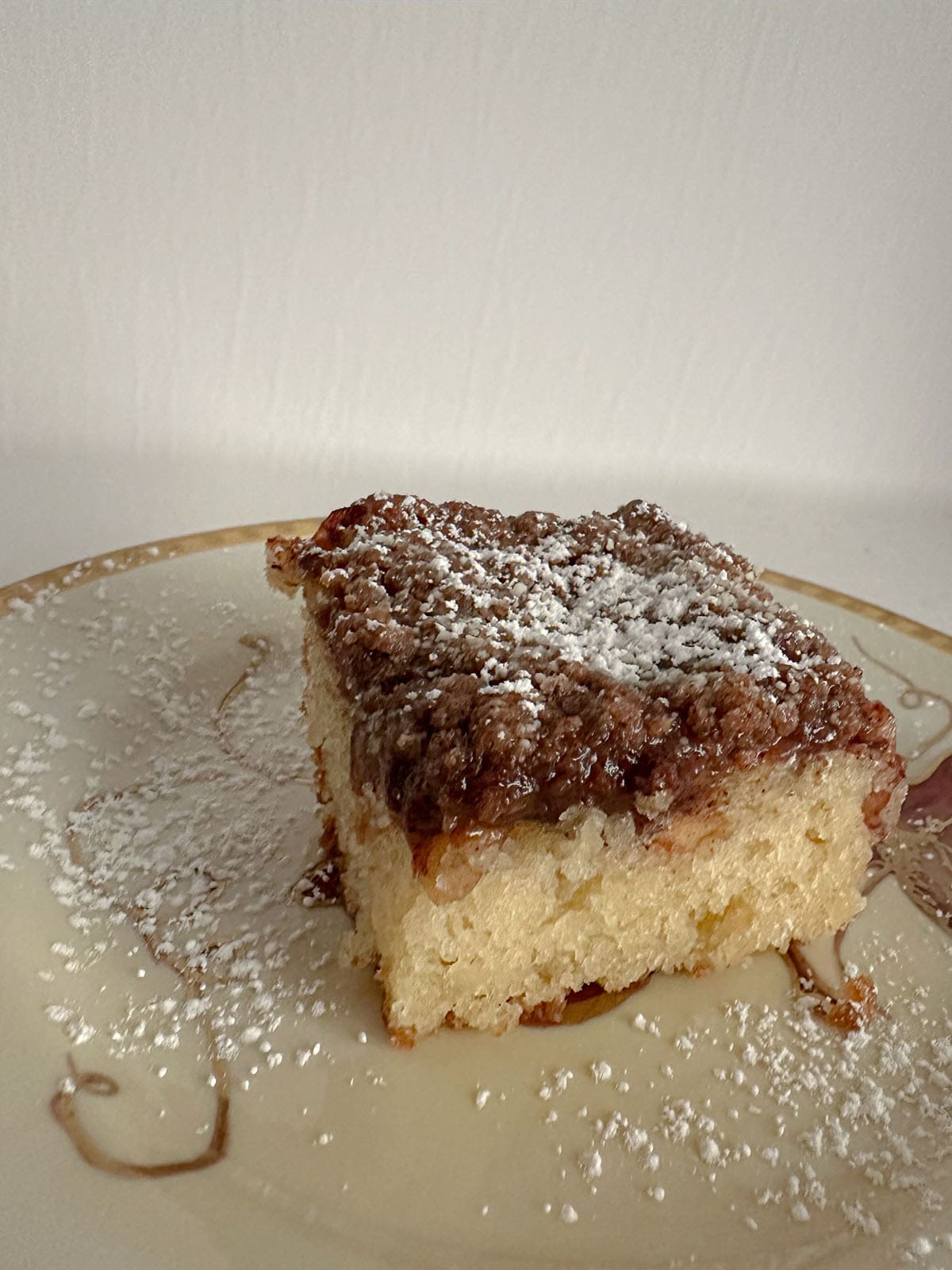 Piece of apple coffee cake on a plate.