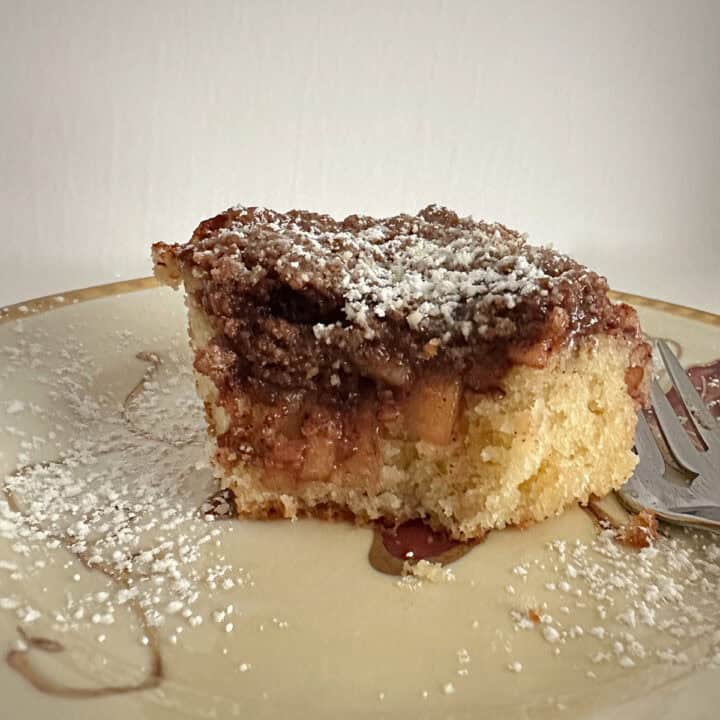Apple streusel coffee cake on a plate with a fork.
