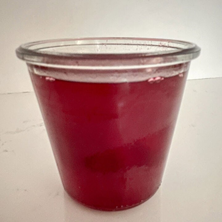 Cranberry simple syrup in a jar.