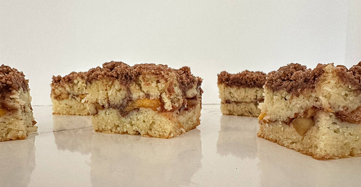 Pieces of peach coffee cake on a table.
