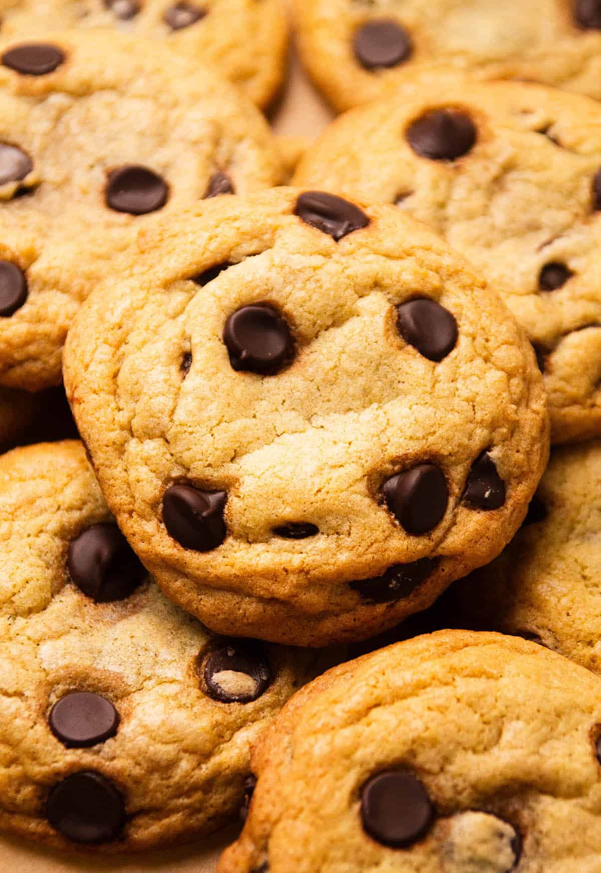 Chocolate chip cookies stacked on to of each other.