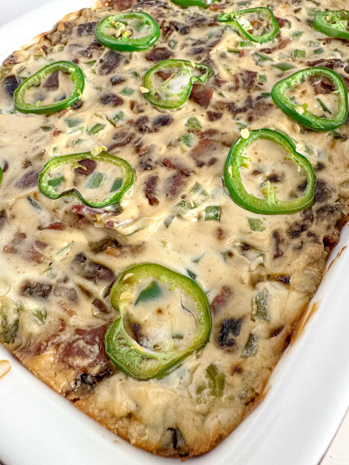 Baked jalapeño date dip in a casserole dish.