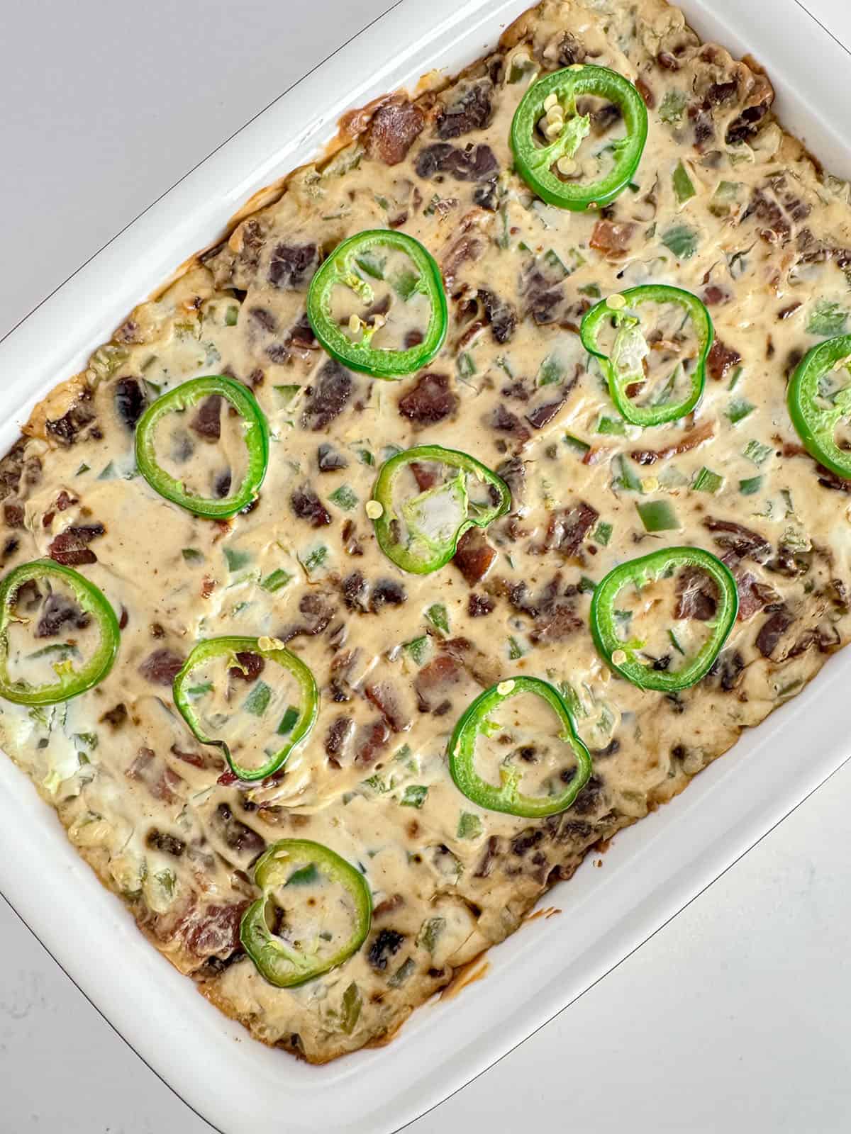 Baked jalapeño dip in a casserole dish.