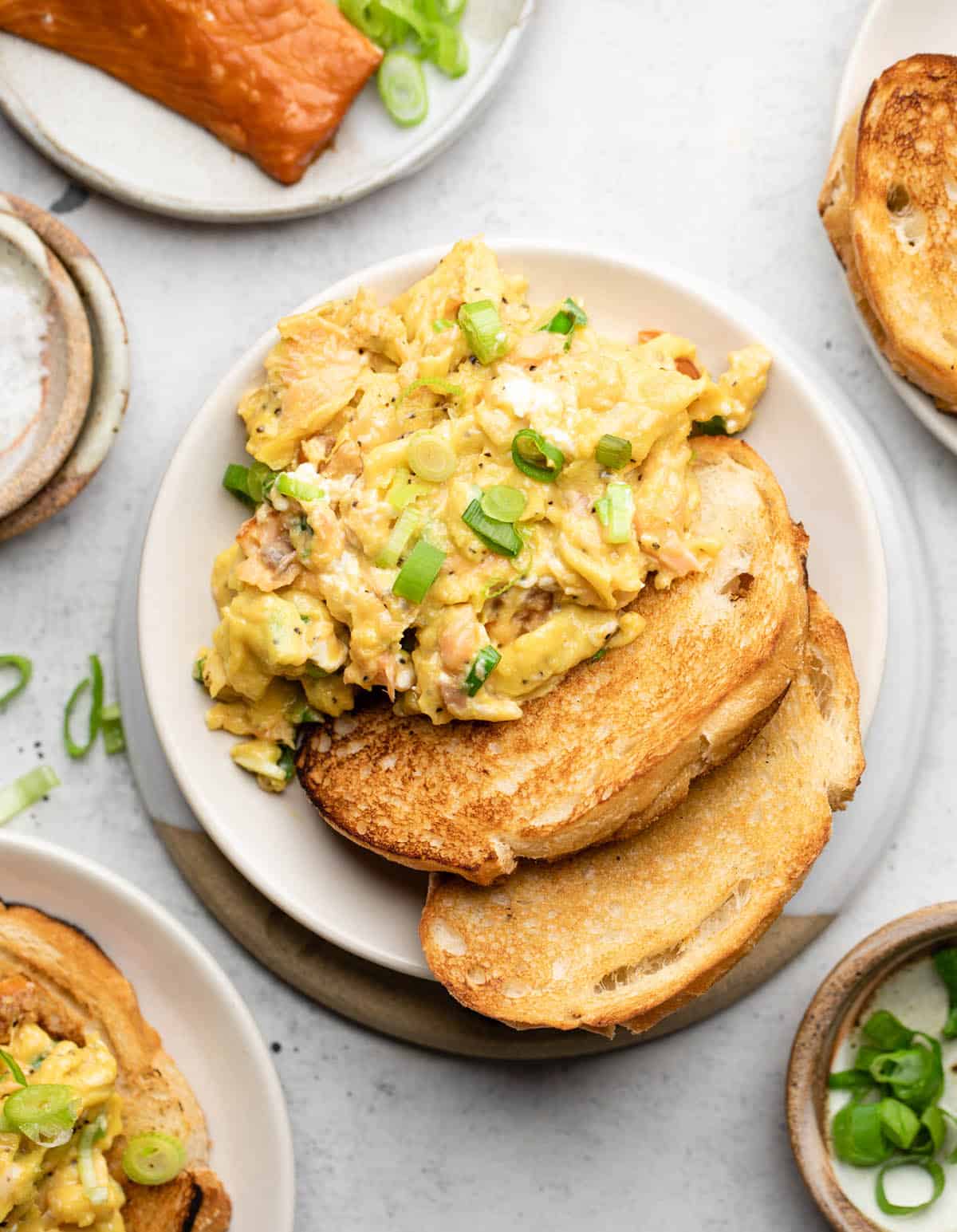 Smoked salmon scrambled eggs with toast on a plate.