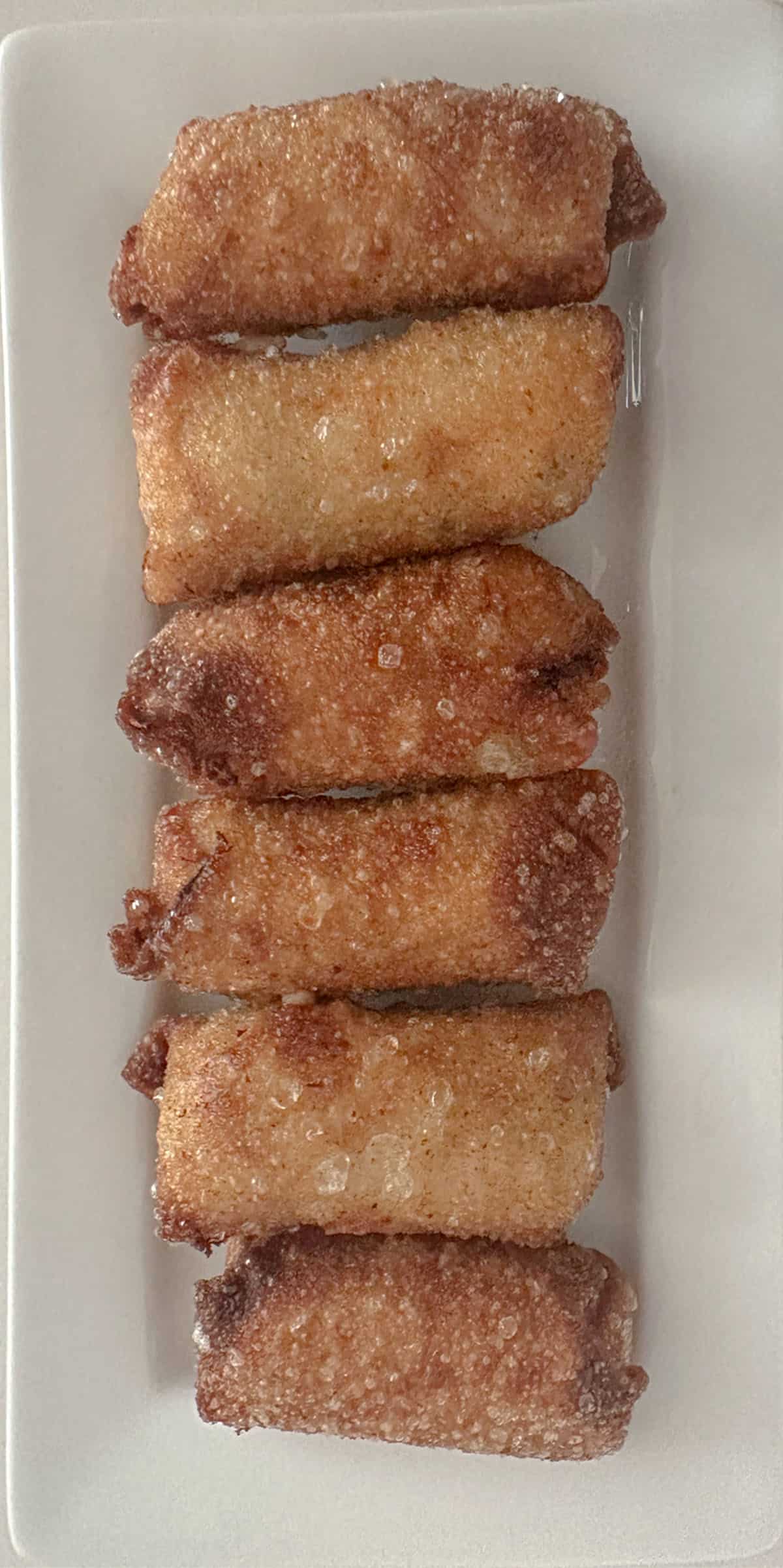 Mini crab egg rolls on a plate.