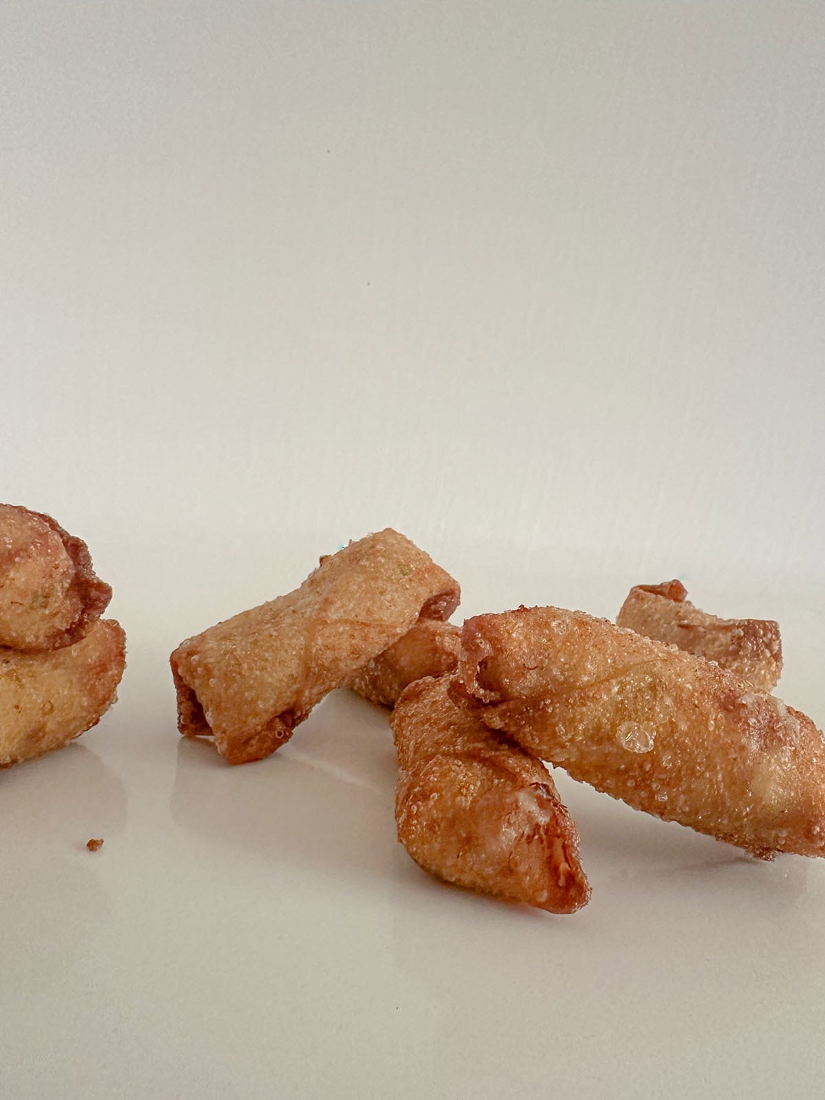 Mini crab egg rolls on a table.