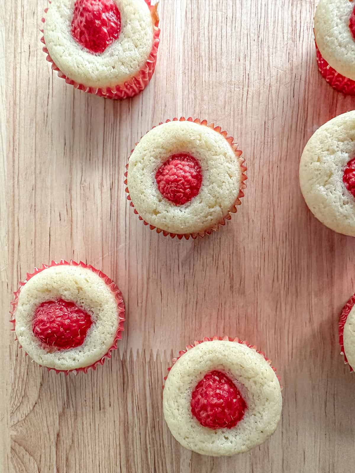 Raspberry muffins on a table.