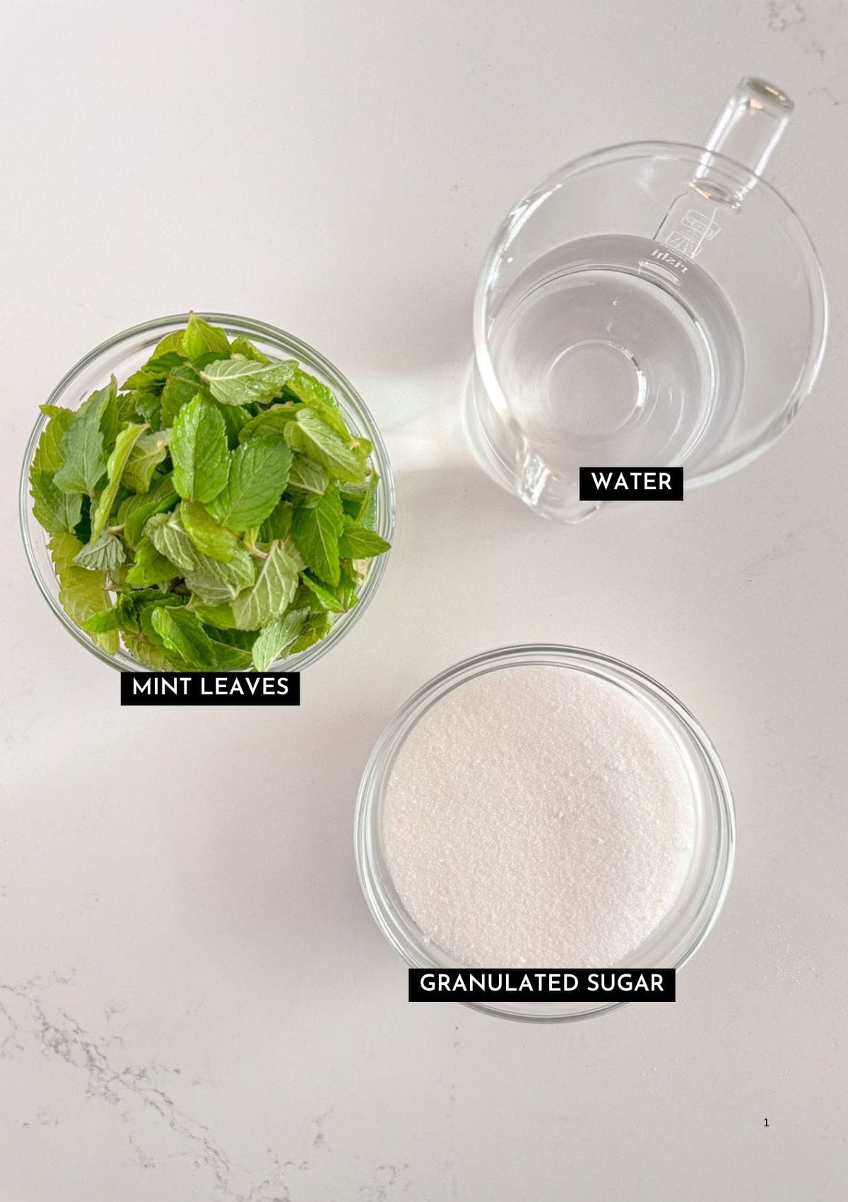 Mint leaves, water, and granulated sugar in individual bowls.